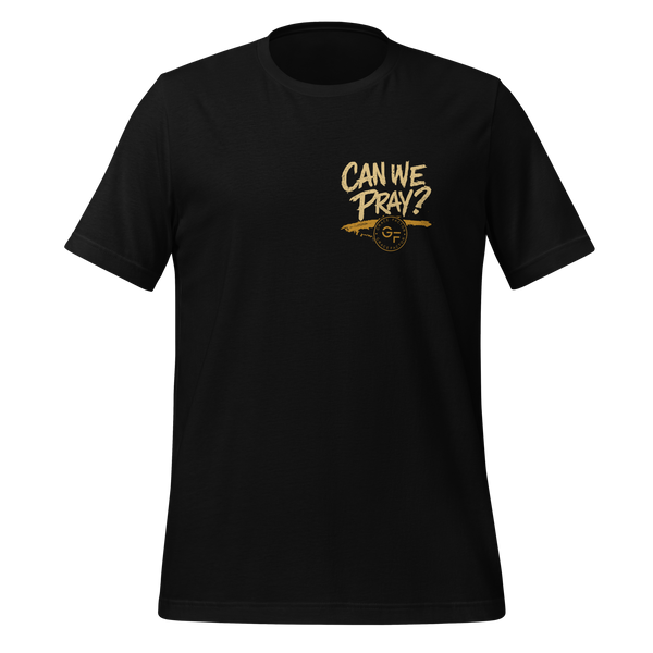 A black short-sleeve crewneck t-shirt with a distressed gold graphic on the left chest that reads 'CAN WE PRAY?'